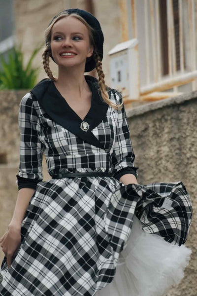 A model wearing a 50's Black Tartan Coat Dress