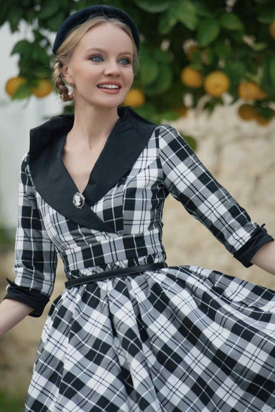 A model wearing a 50's Black Tartan Coat Dress