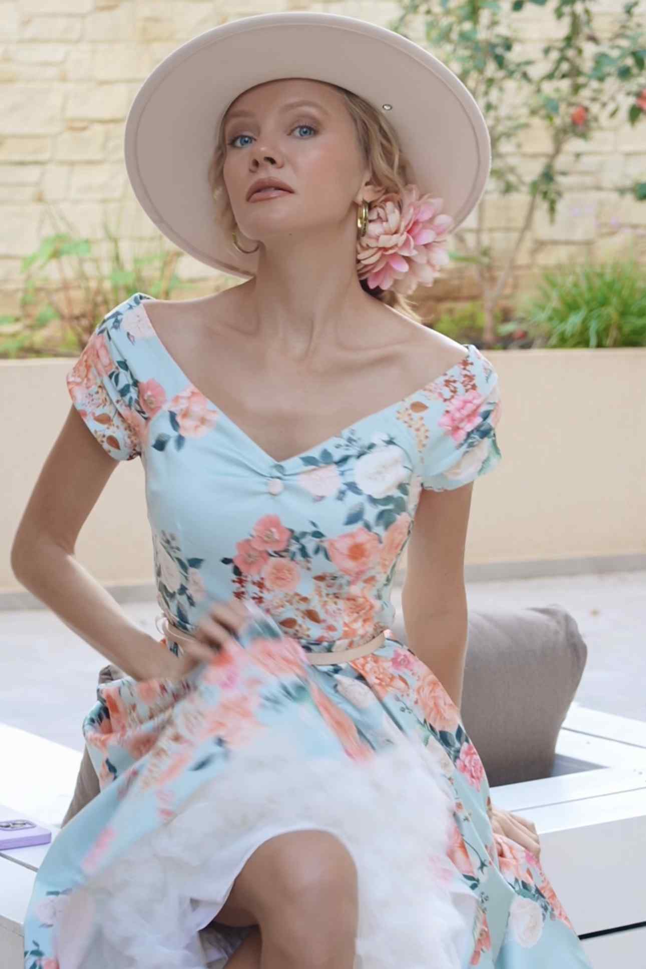 A lady wearing a 50s Style Floral Off Shoulder Dress In Mint