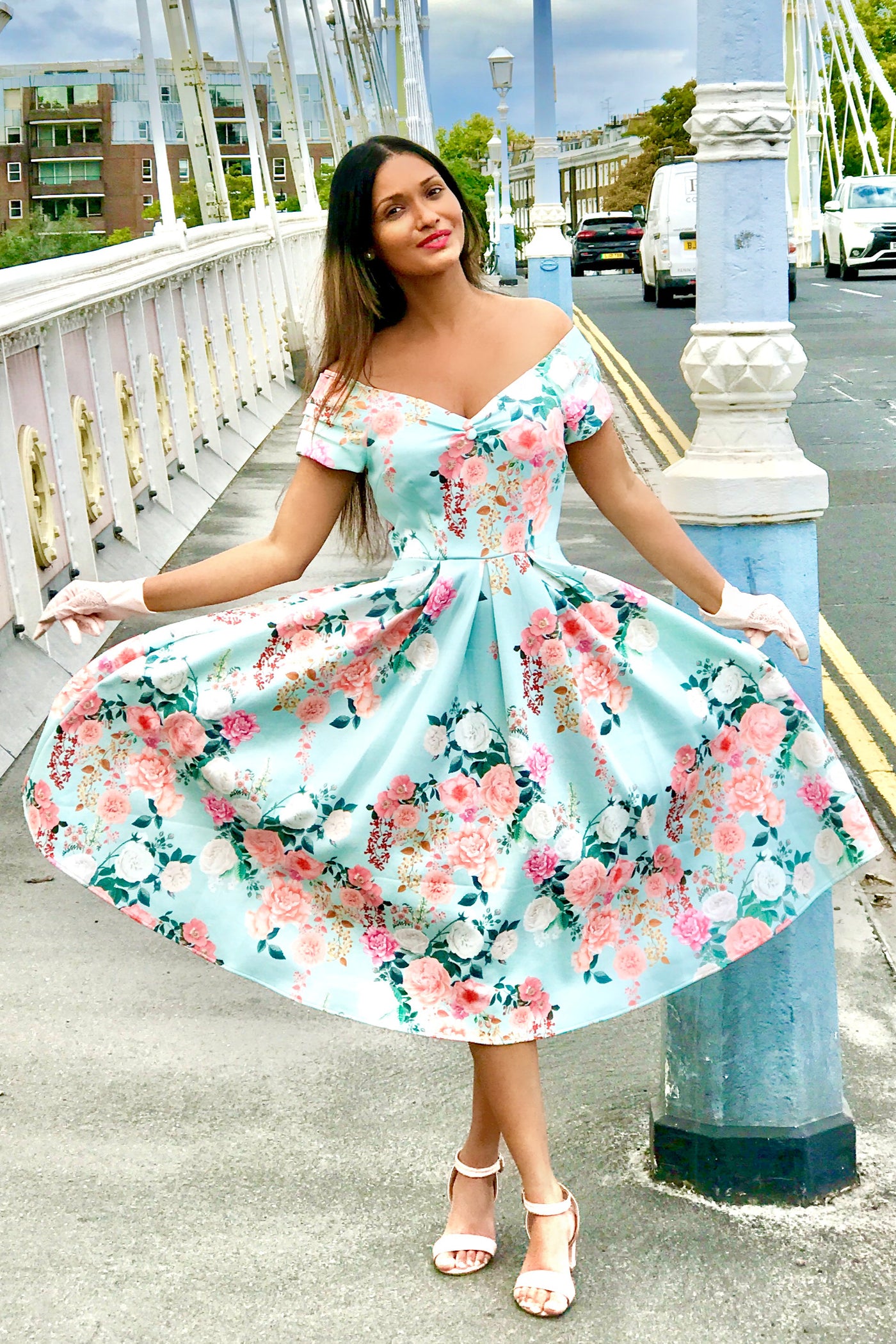 A model wearing a 50s Style Floral Off Shoulder Dress In Mint