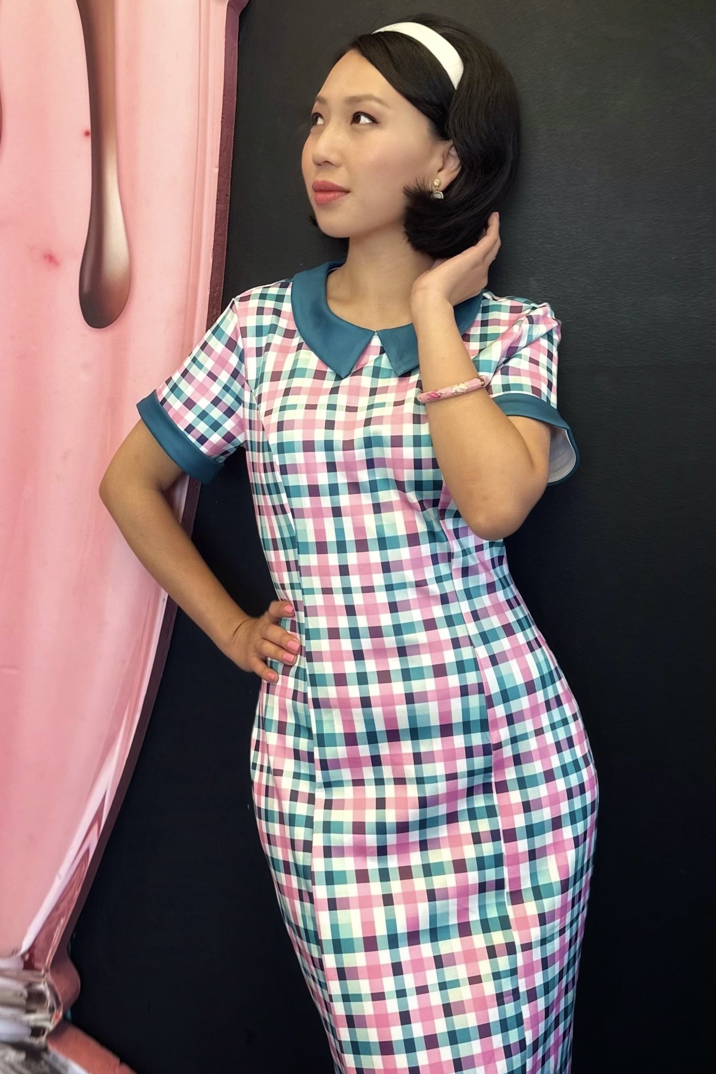 A model wearing a 50s Style Pink & Green Check Collar Dress