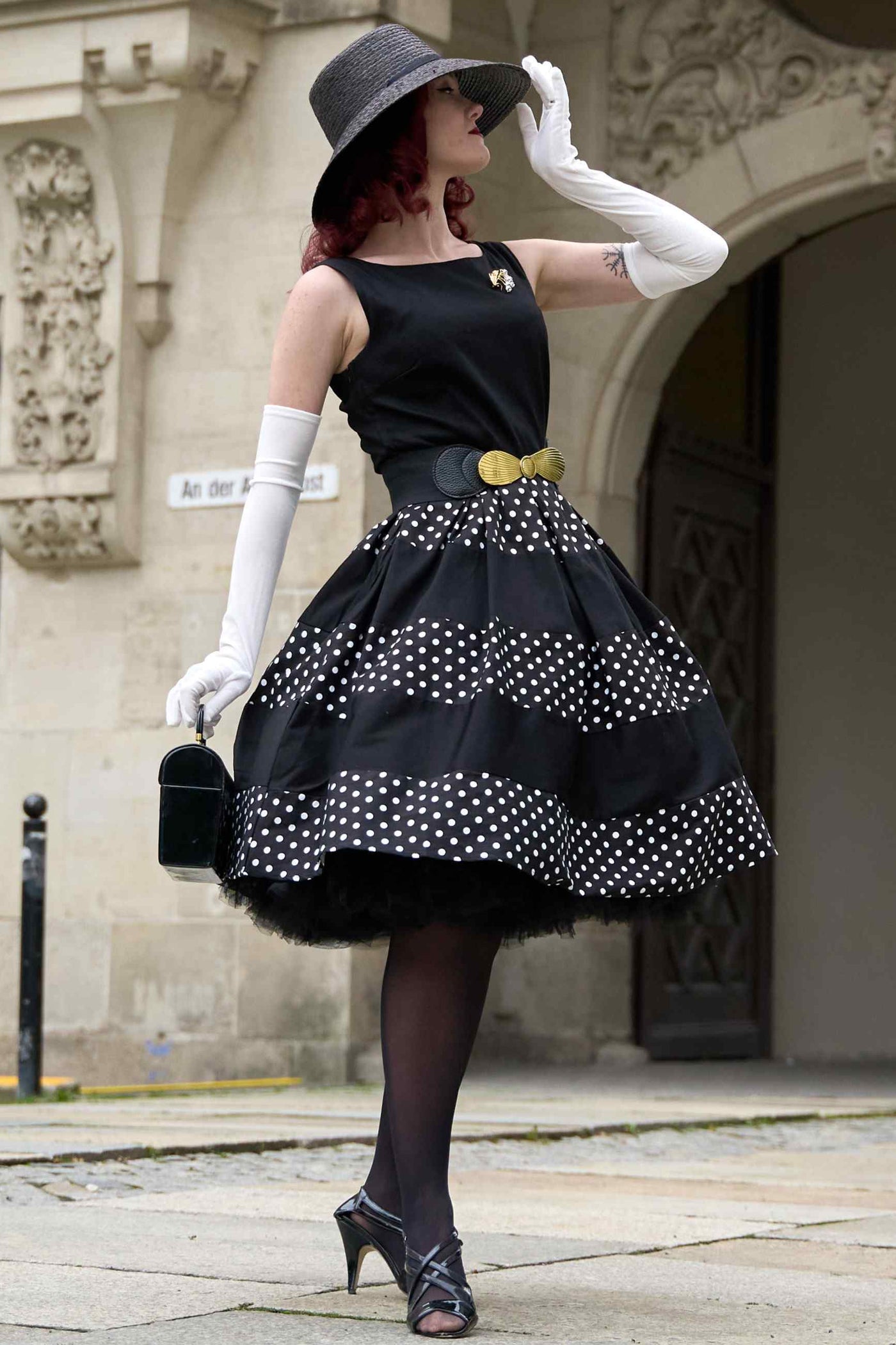 A lady 50s Inspired Swing Dress in Black Polka Dots