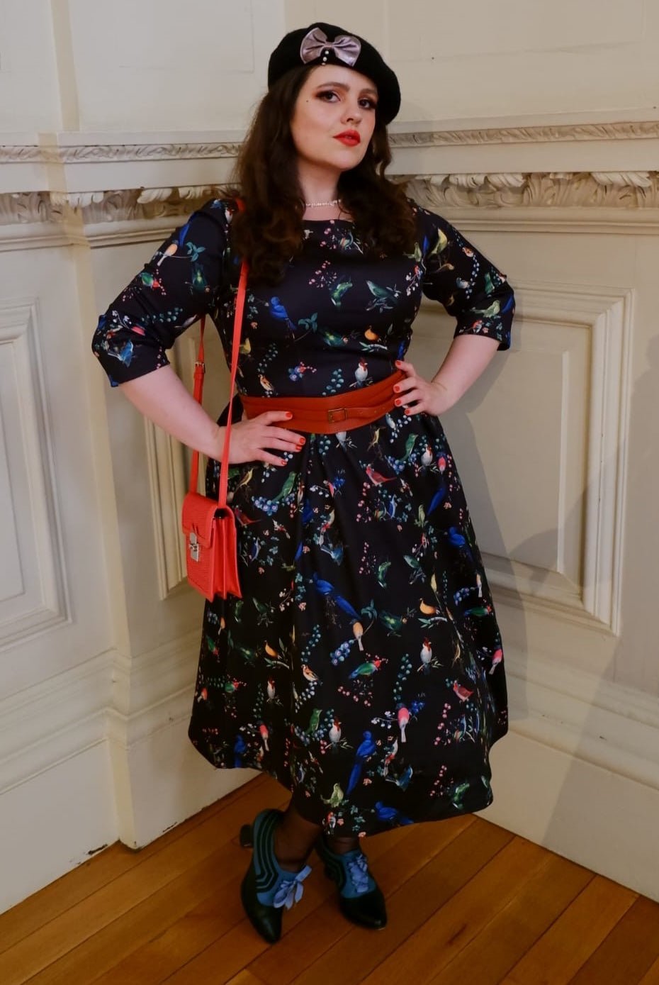 A model wearing Long Sleeved Midi Dress in Black Bird Print