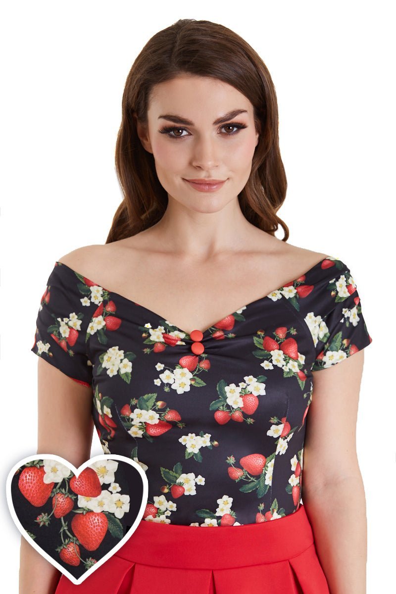 Model wears our V neck, off shoulder, short sleeve top, in black, with red strawberry print, top view