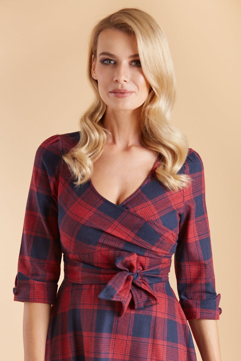 Model wearing red blue tartan sleeved dress close up