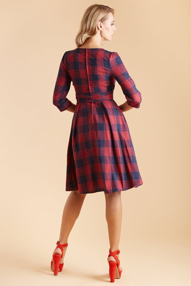 Model wearing red blue tartan sleeved flared dress back view