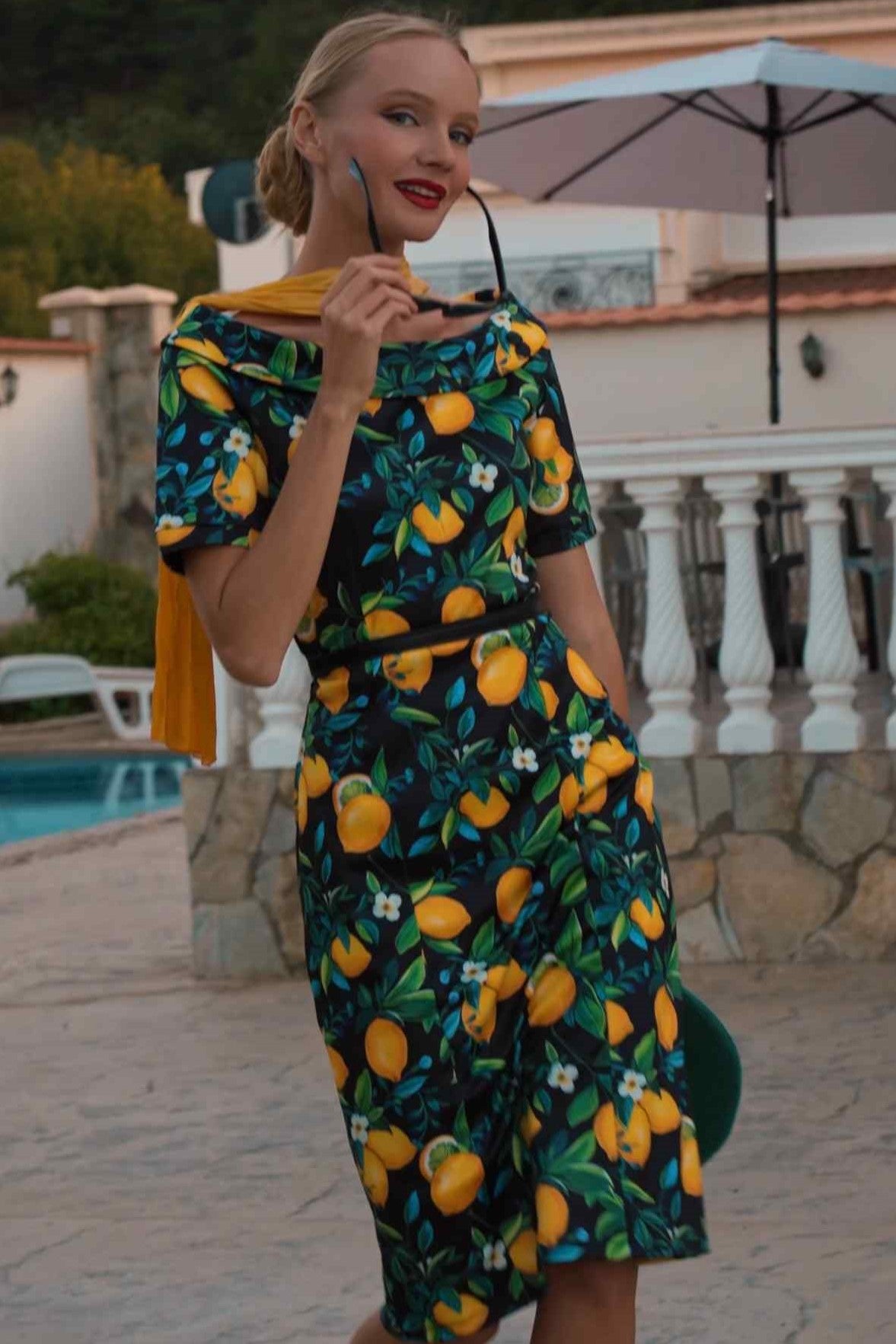 A lady wearing a Summer Lemon Fitted Off Shoulder Dress