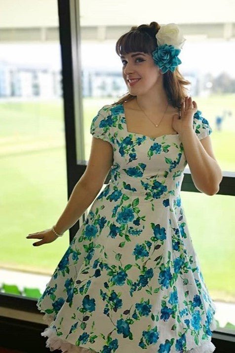 Customer wearing white/blue floral dress