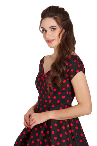 Model wearing a Rockabilly Polka Dot Off Shoulder Swing Dress In Black & Red