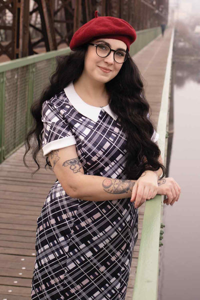 A lady wearing a Black Checkered Wiggle Collar Dress