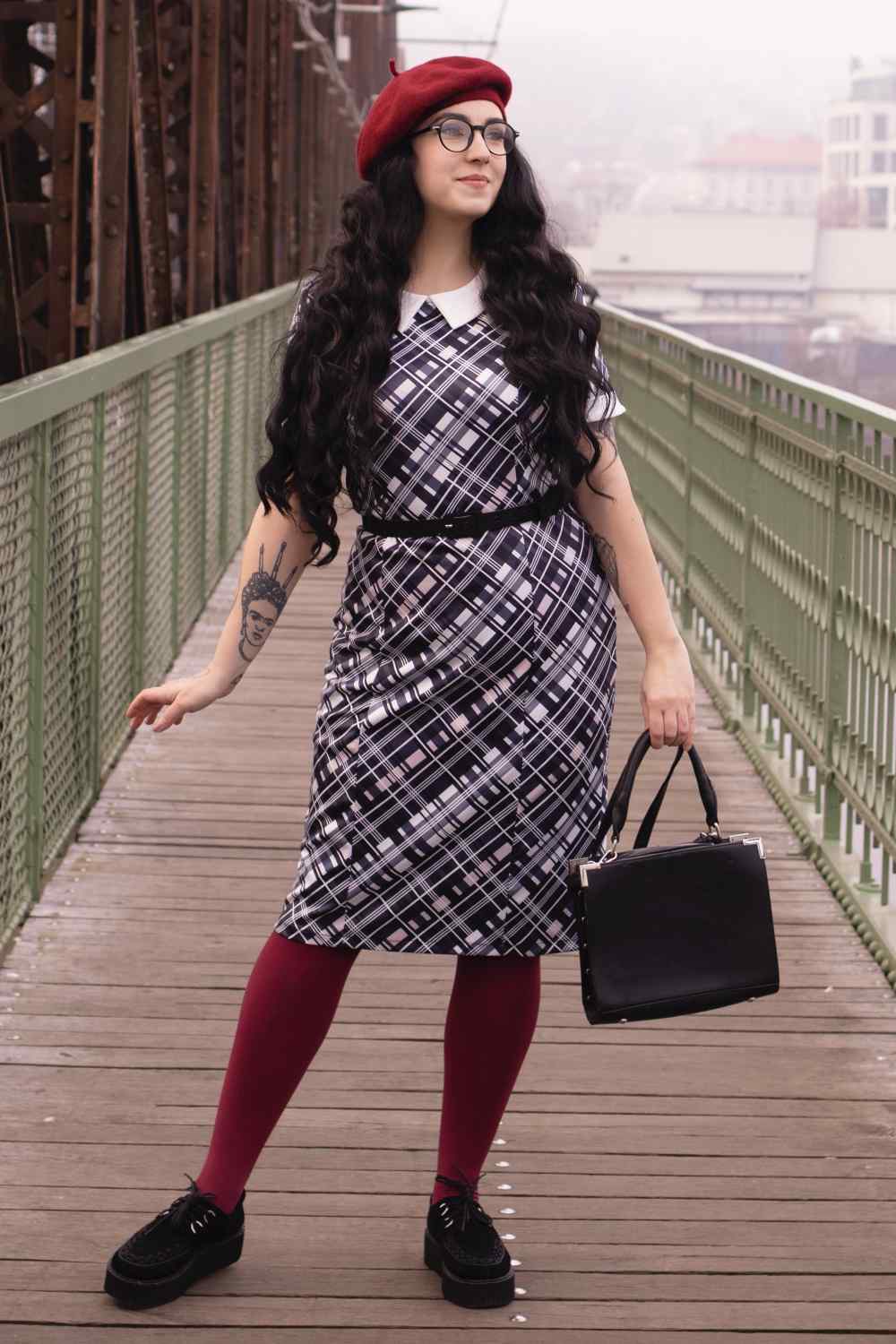 A lady wearing a Black Checkered Wiggle Collar Dress