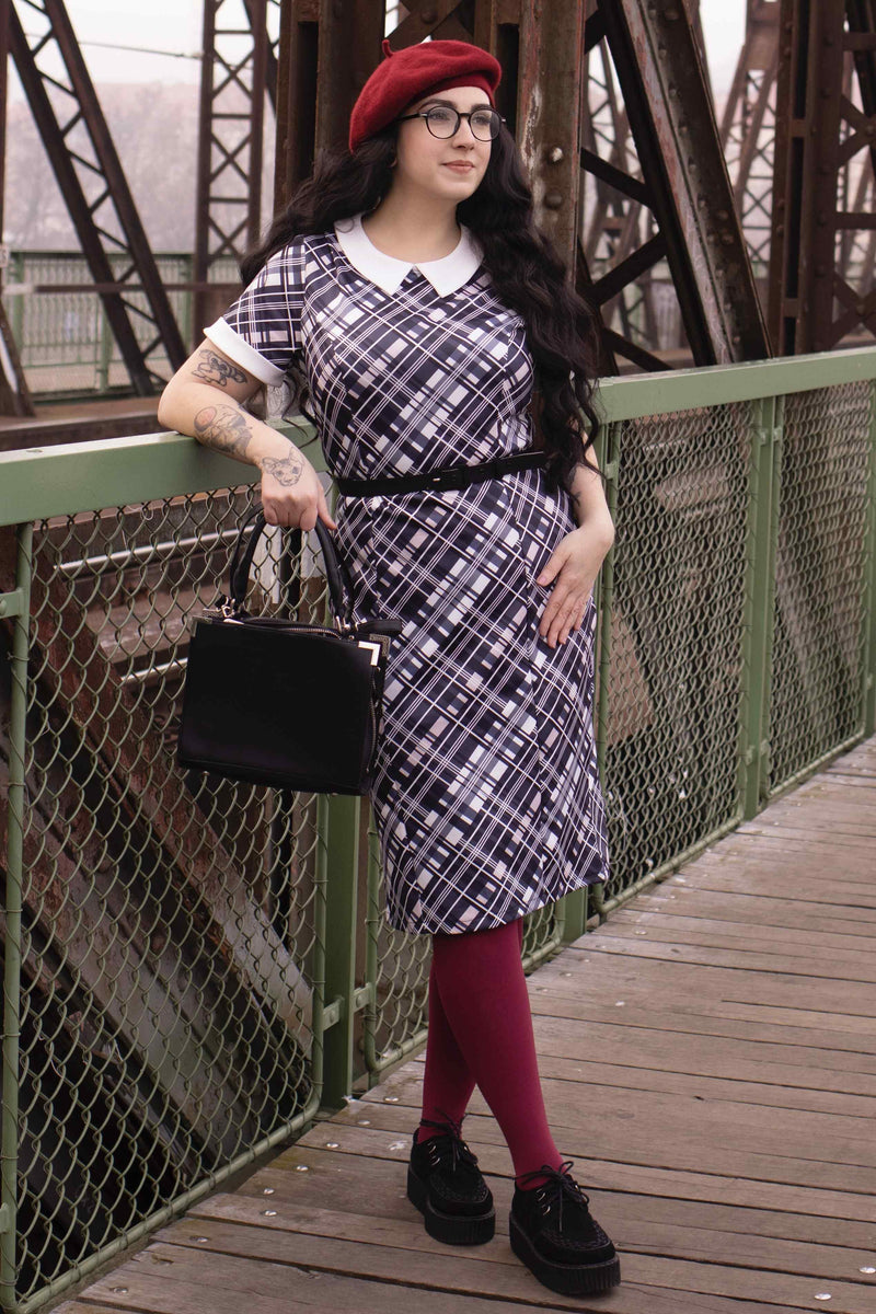 A lady wearing a Black Checkered Wiggle Collar Dress