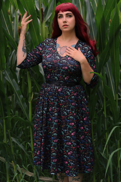 A lady wearing a Black Dinosaur Skeleton Fossil Dress