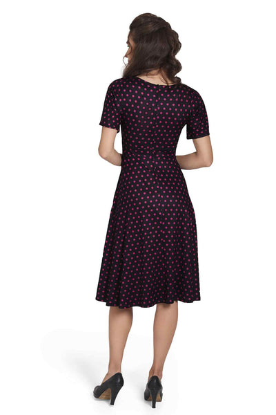 Model wearing Sleeved Flared Tea Dress in Black Polka Dot Print