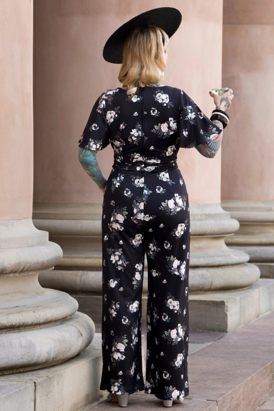 A model wearing Black Rose Butterfly Sleeved Jumpsuit