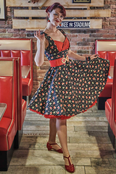 A model wearing a Black Strawberry Pleated Bust Dress