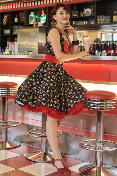 A model wearing a Black Strawberry Pleated Bust Dress