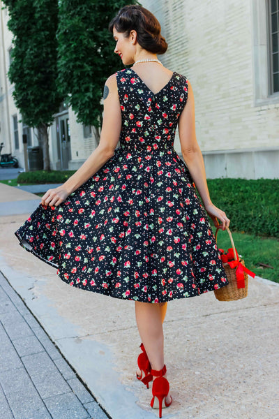 A model wearing a Black Strawberry Pleated Bust Dress