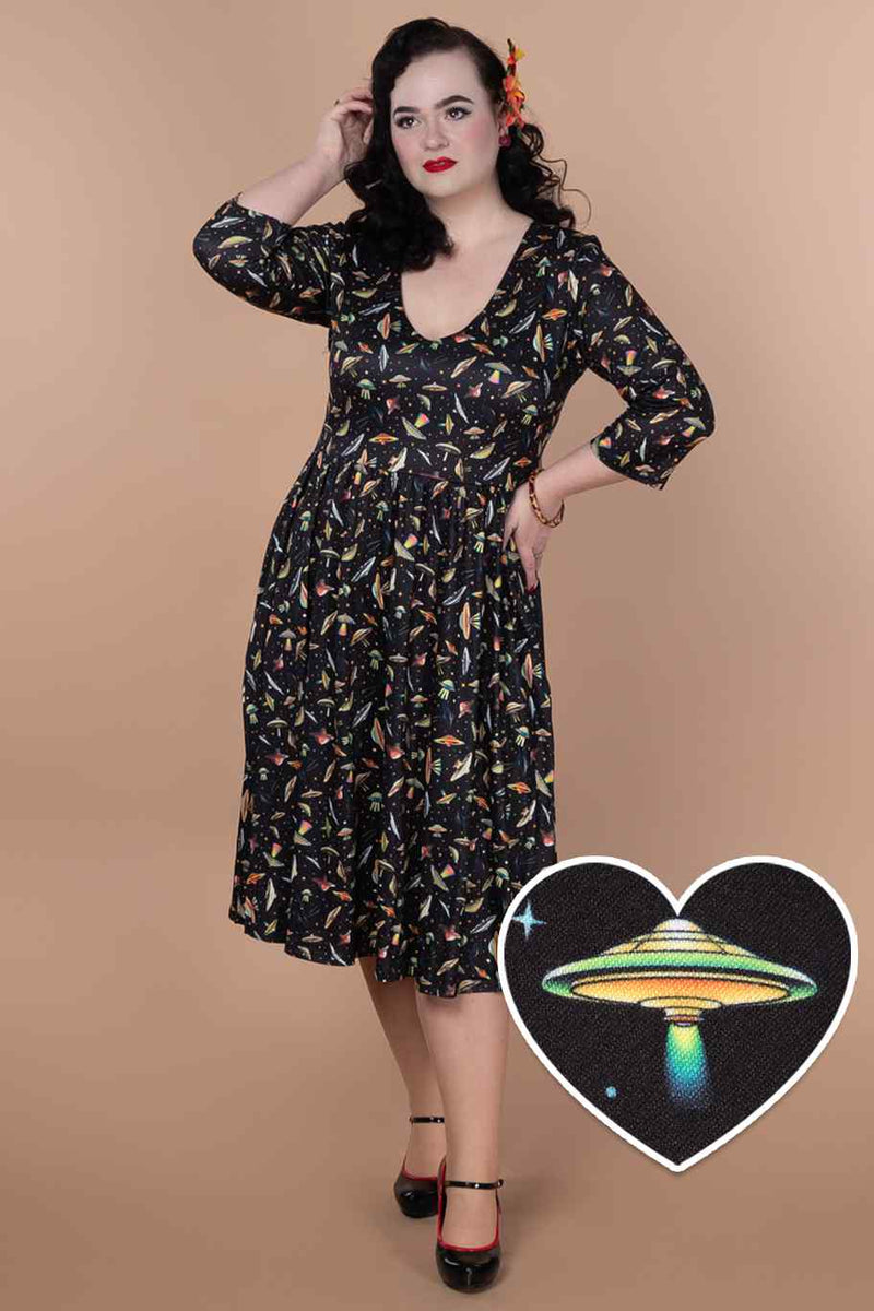 A lady wearing a Black UFO Spaceship Flared Dress