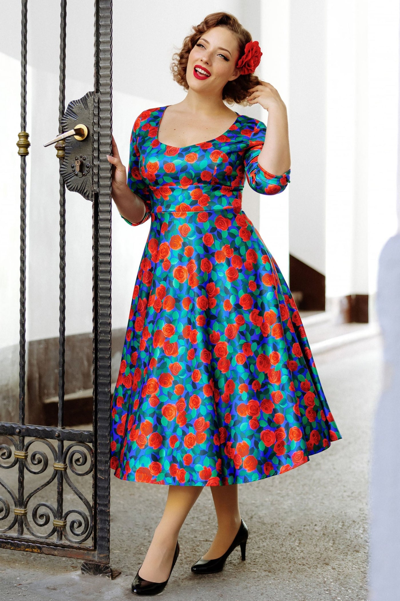 A model wearing a Blue & Red Rose Dress