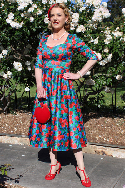 A model wearing Blue & Red Rose Dress