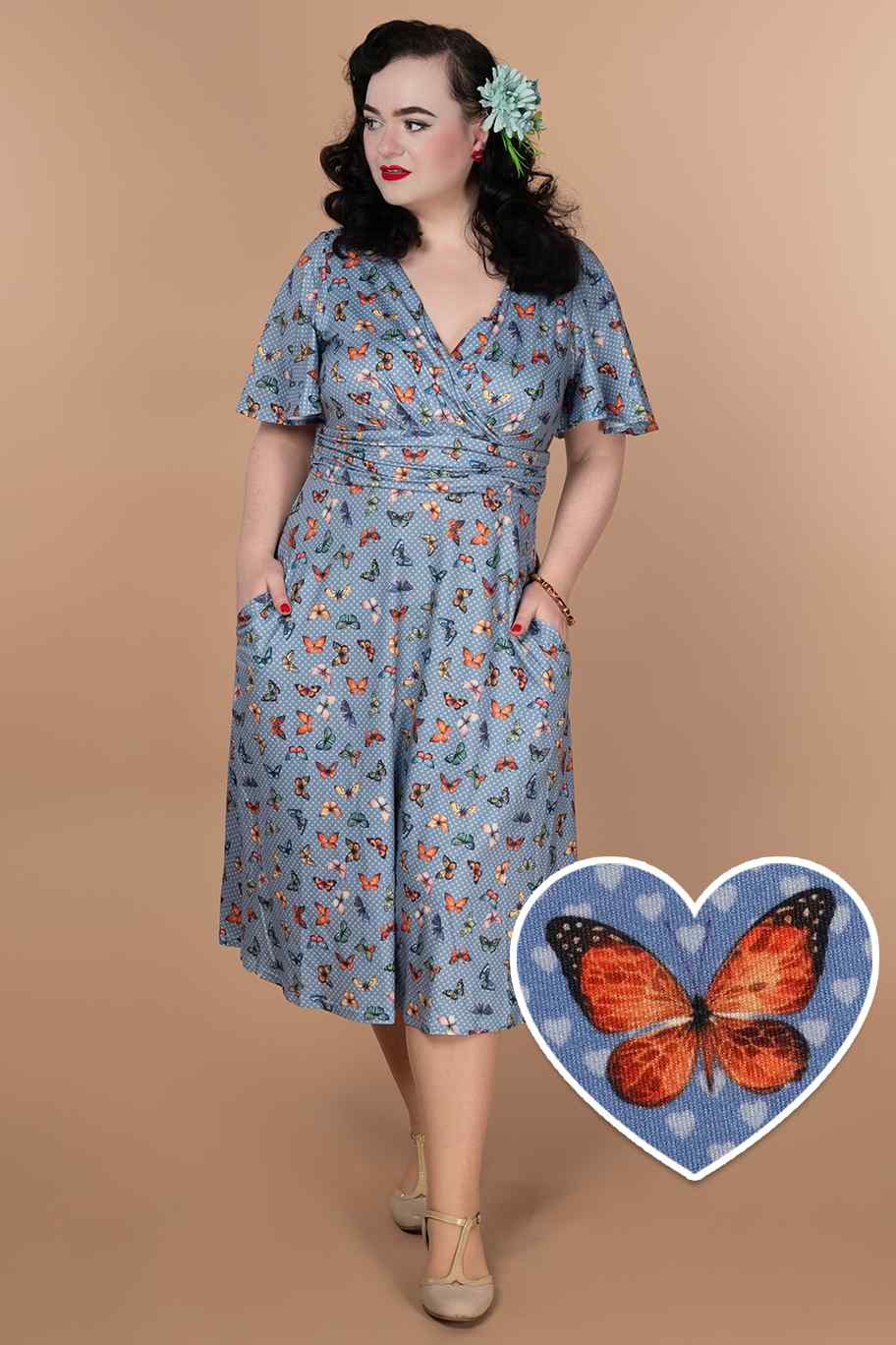 A model wearing A Blue Butterfly Polka Dot Tea Dress