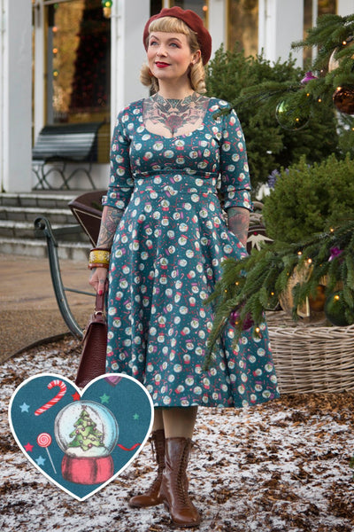 A model wearing Blue Snow Globe Long Sleeved Dress