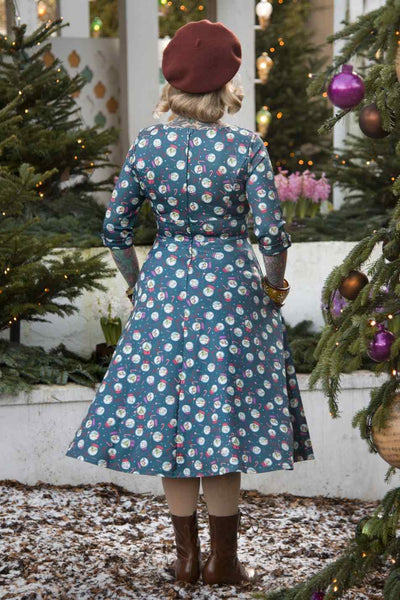 Back view of model wearing Blue Snow Globe Long Sleeved Dress