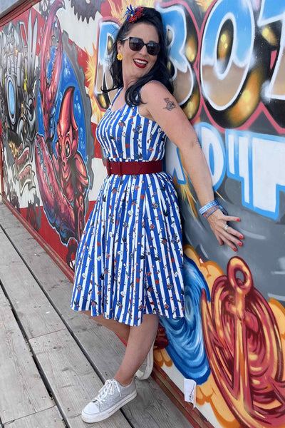 A lady wearing a Blue Striped Rockabilly Swallow Swing Dress