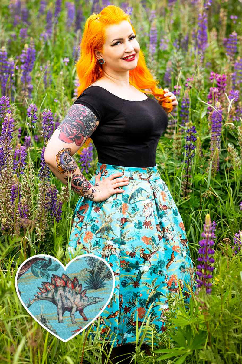 A model wearing Box Pleated Skirt in Dinosaur Print