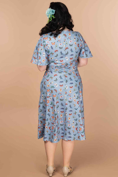 A model wearing A Blue Butterfly Polka Dot Tea Dress