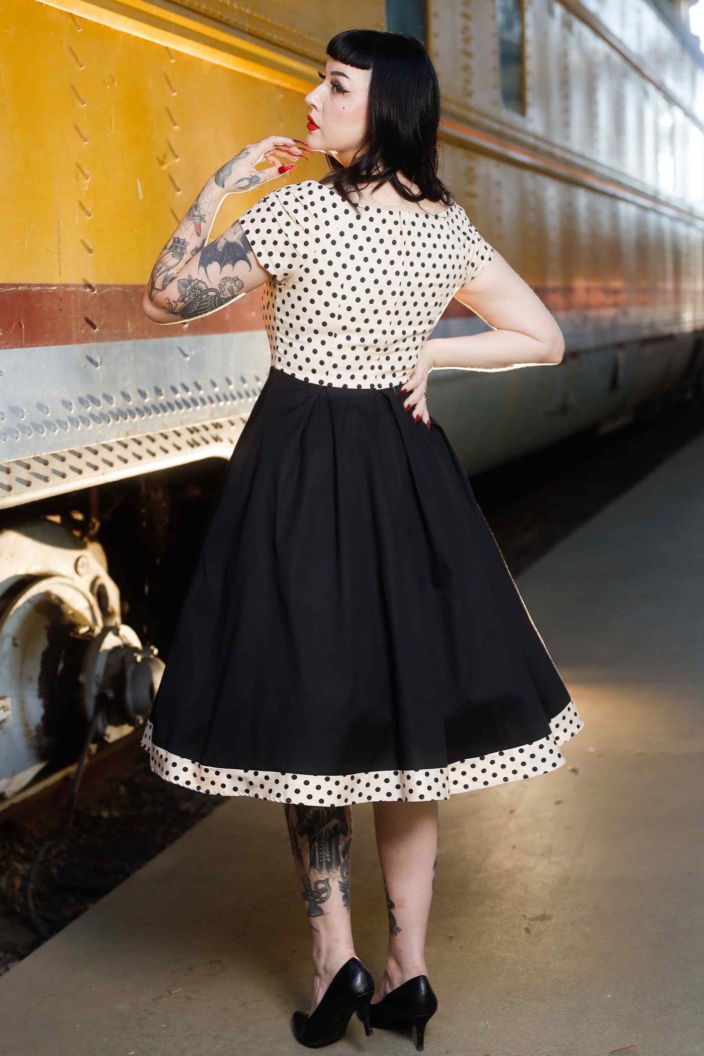 Back view of model wearing Cream & Black Polka Dot 50s Swing Dress