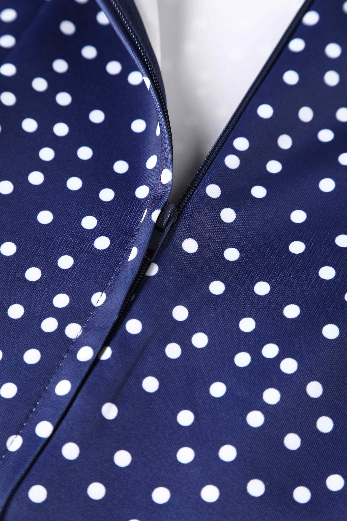 Close up view of Cross Strap Fitted Dress in Blue Polka Dots