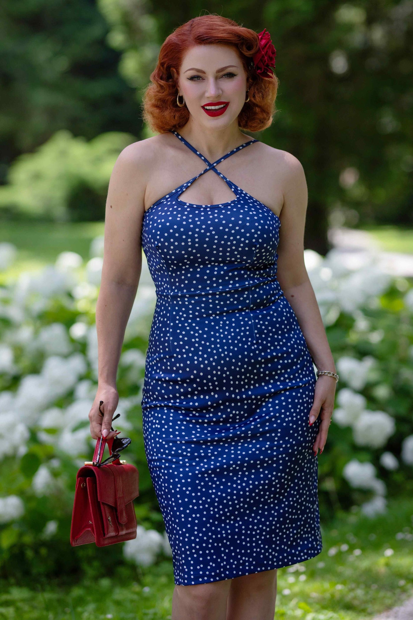 Model wearing a Cross Strap Fitted Dress in Blue Polka Dots