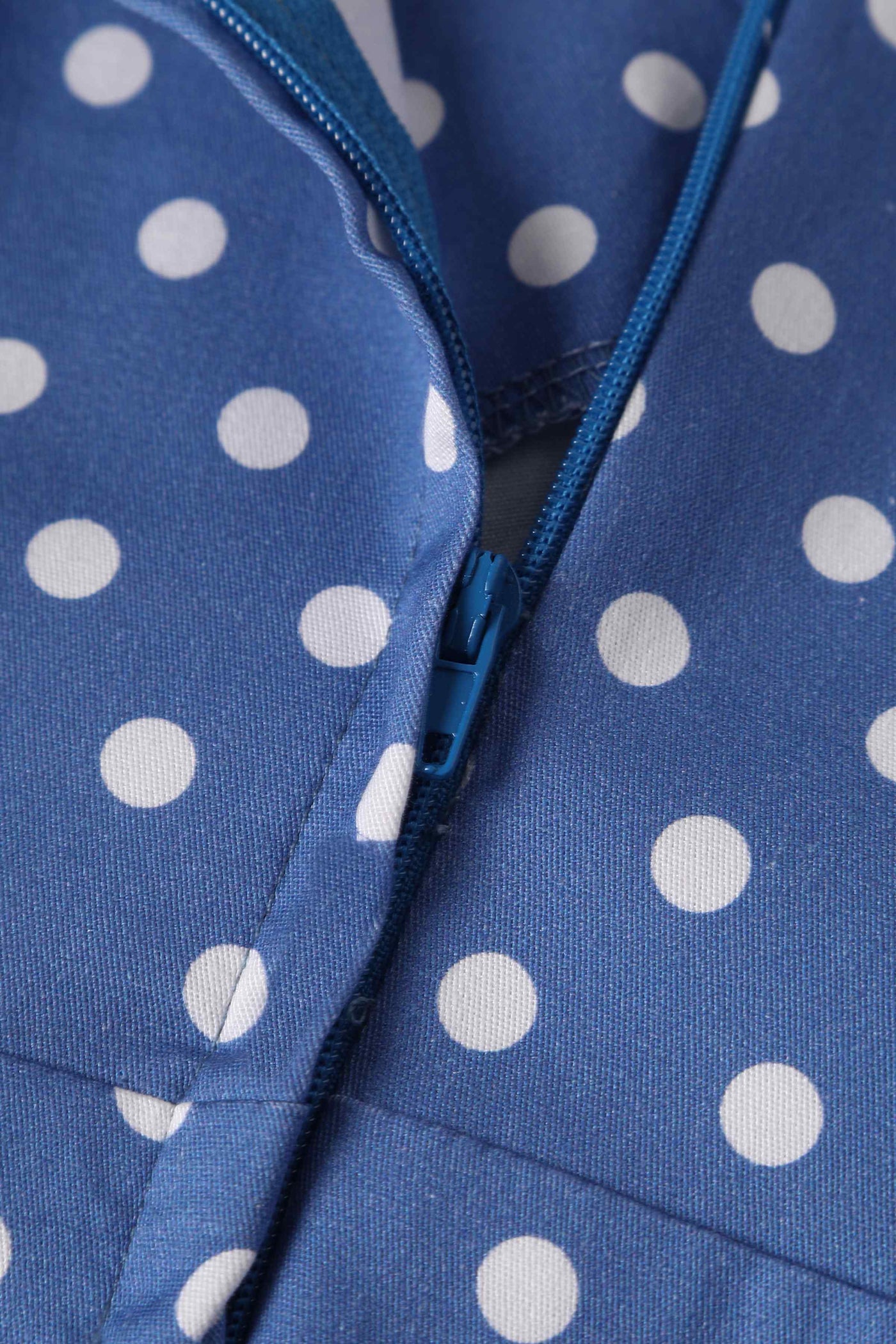 Close up view of Crossover Bust Blue and White Polka Dot Dress