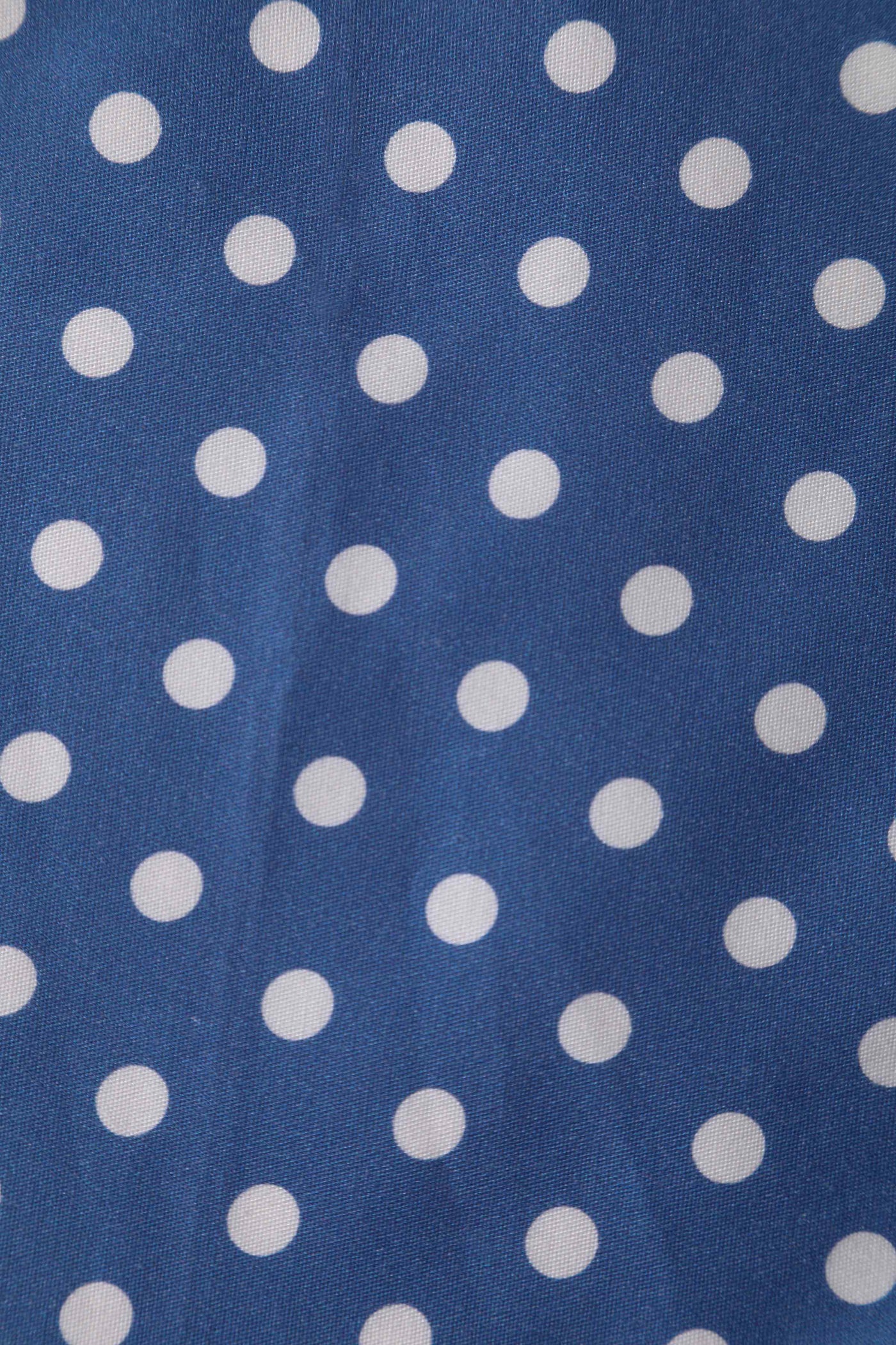 Close up view of Crossover Bust Blue and White Polka Dot Dress