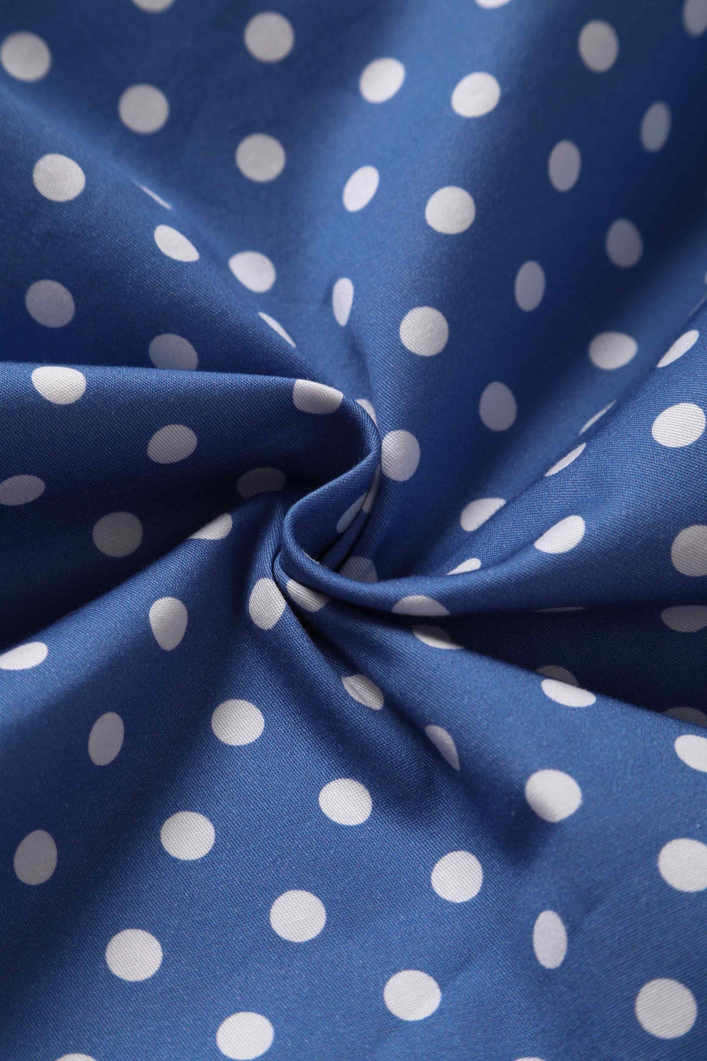 Close up view of Crossover Bust Blue and White Polka Dot Dress