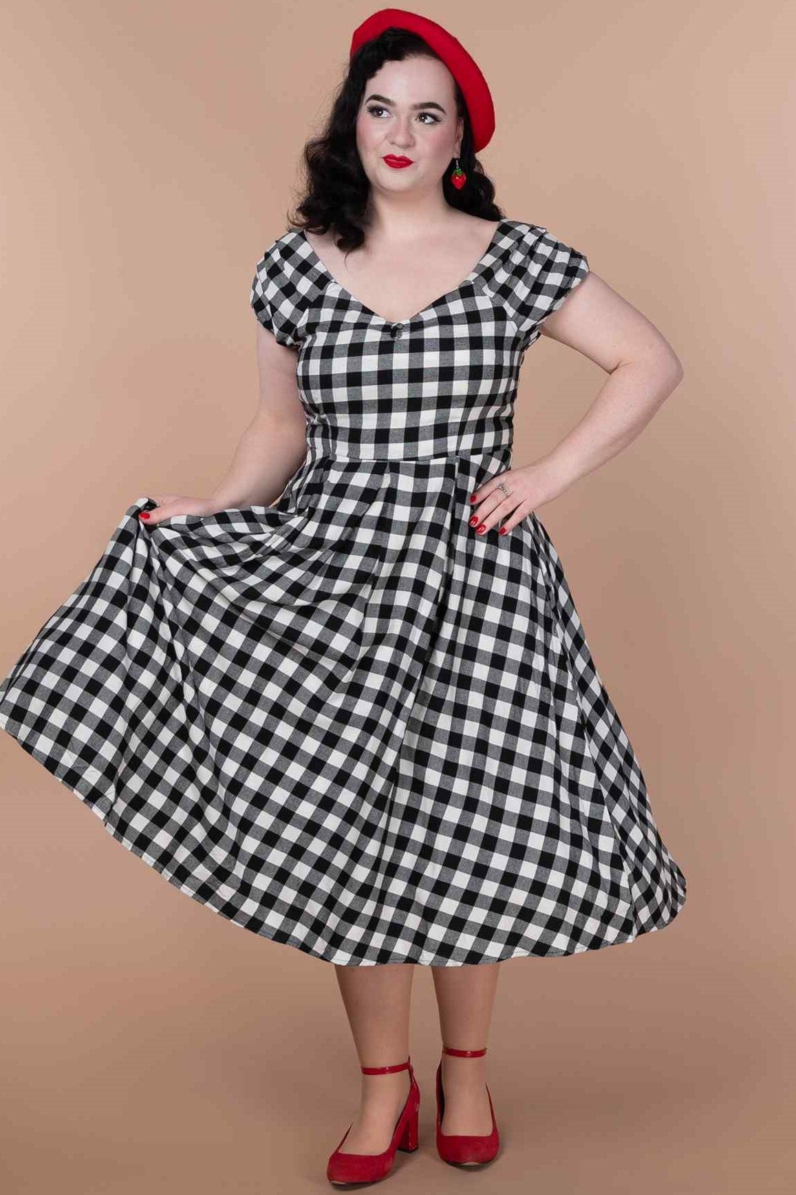 A lady wearing an Off Shoulder Black Gingham Check Circle Dress