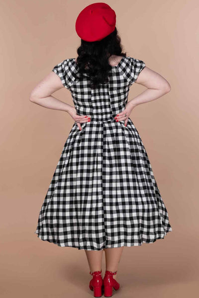 A lady wearing an Off Shoulder Black Gingham Check Circle Dress