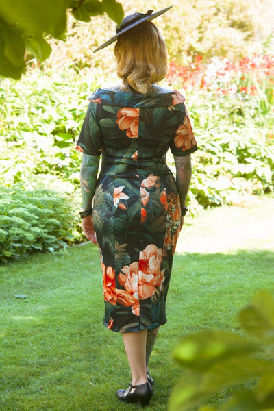 A model wearing a  Fitted Off Shoulder Dress In Tiger Print