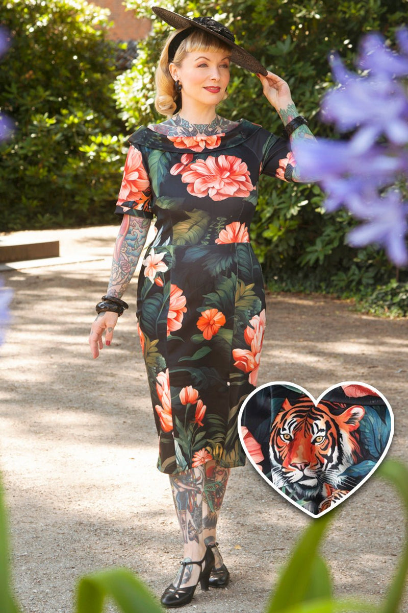 A model wearing a  Fitted Off Shoulder Dress In Tiger Print