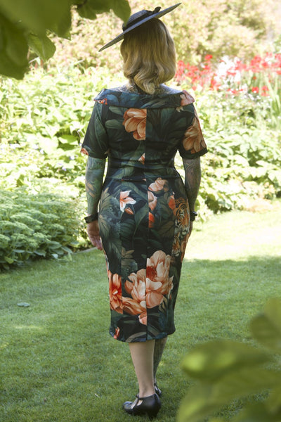 A model wearing a Fitted Off Shoulder Dress In Tiger Print