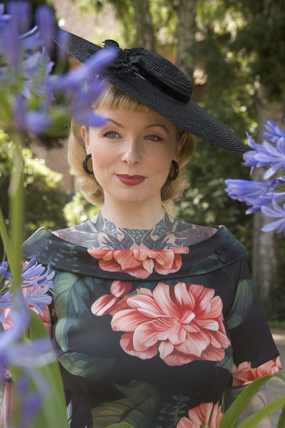 A model wearing a Fitted Off Shoulder Dress In Tiger Print