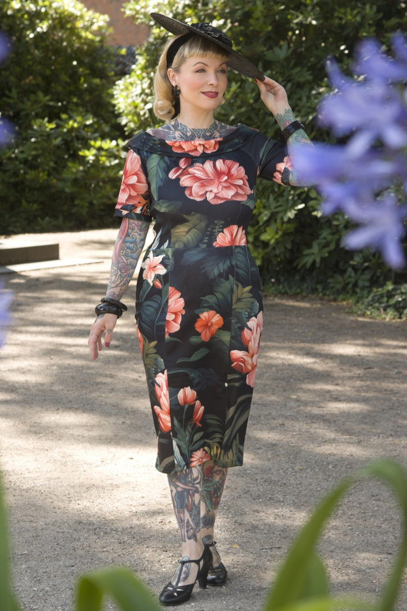 A model wearing a Fitted Off Shoulder Dress In Tiger Print