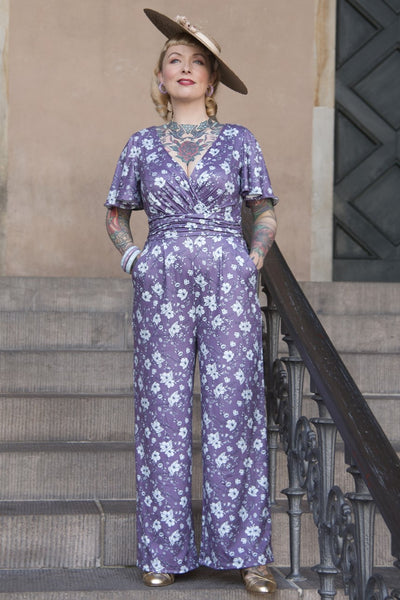 A model wearing a Purple Floral Butterfly Sleeved Jumpsuit