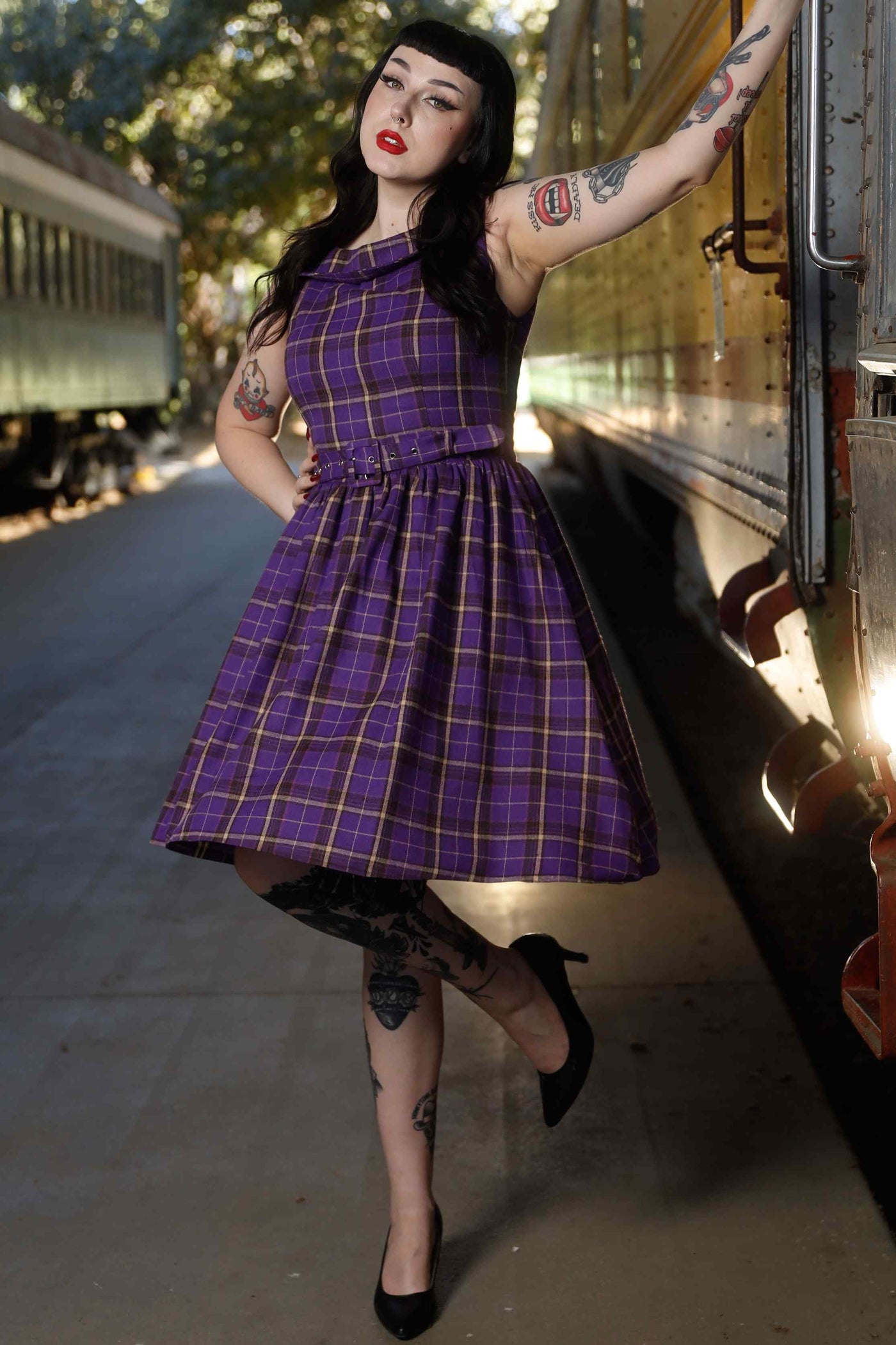 Front view of model wearing Full Circle Dress in Purple Tartan