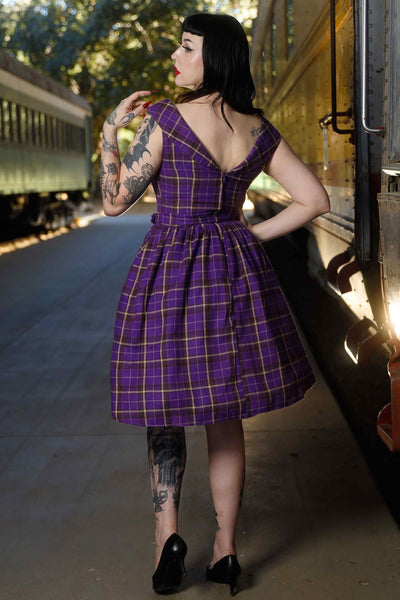 Back view of model wearing Full Circle Dress in Purple Tartan