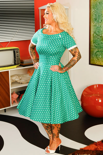 A model wearing a Full Circle Green Polka Dot Swing Dress