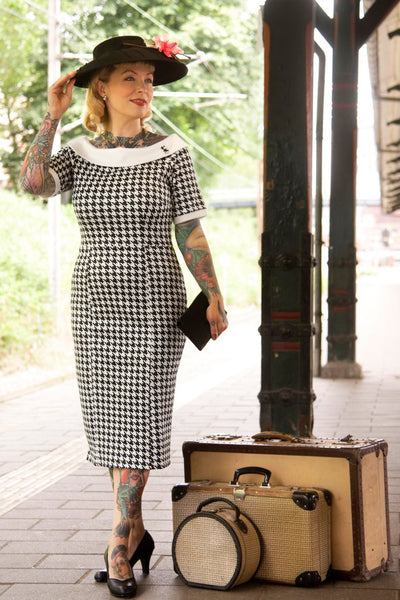 A model wearing a Houndstooth Fitted Off Shoulder Dress