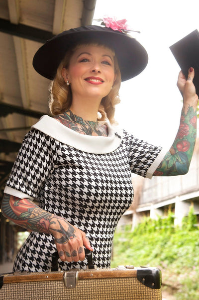 A model wearing a Houndstooth Fitted Off Shoulder Dress